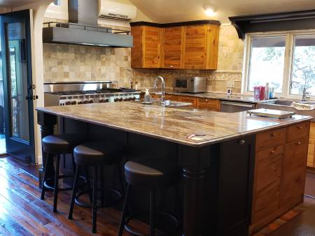 Modern kitchen with island and bar stools.