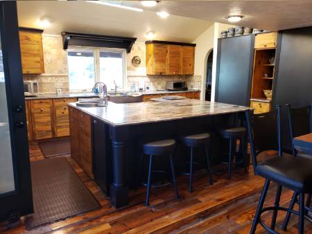 Rustic kitchen with island and wooden cabinets.