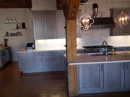 Modern kitchen with gray cabinets and island.